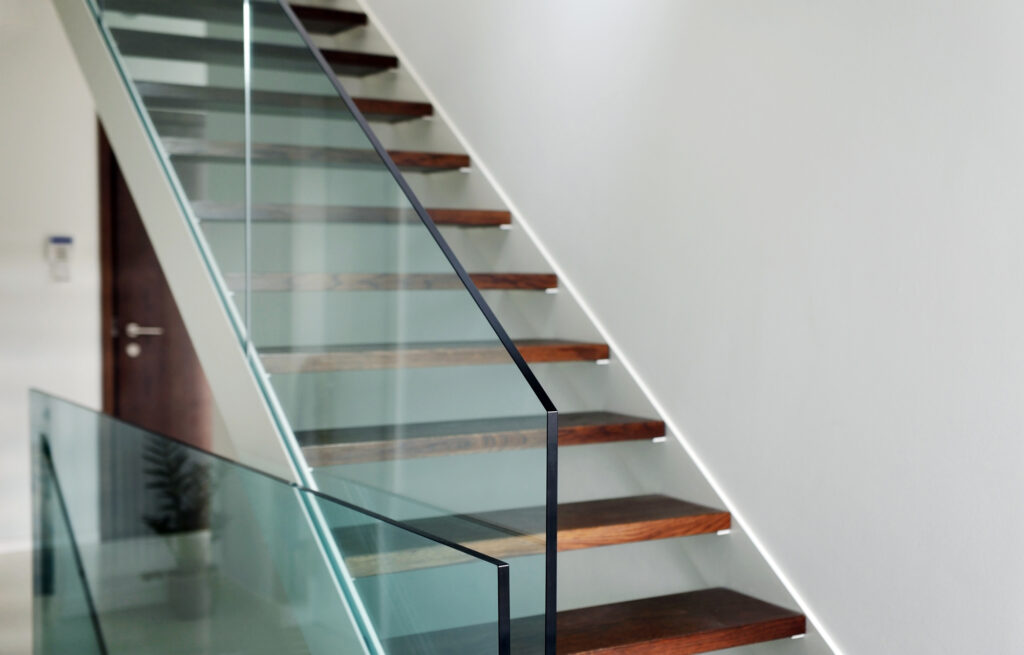 Frameless glass balustrade beside a floating timber staircase