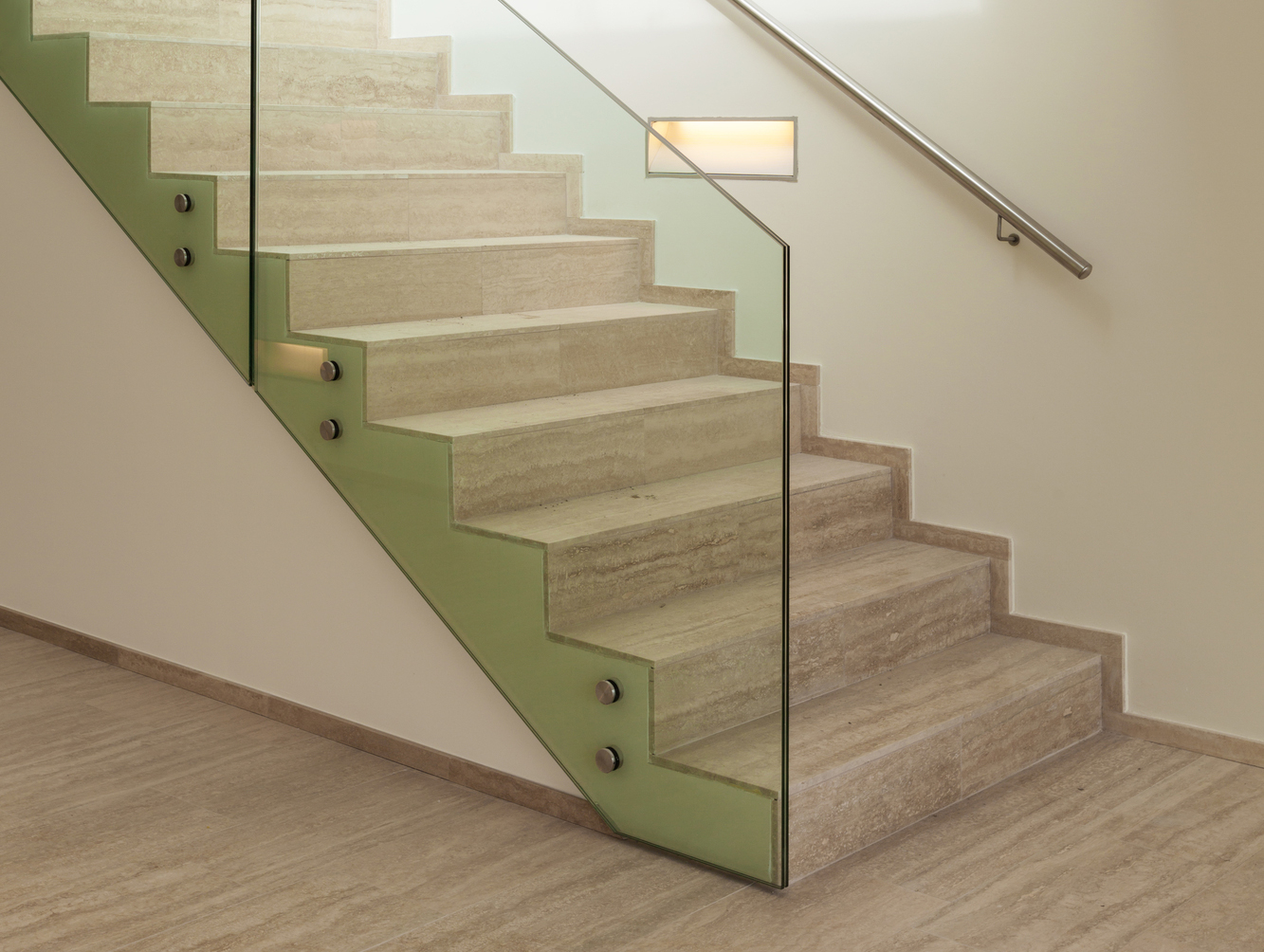Side-mounted frameless glass balustrade on a stone staircase