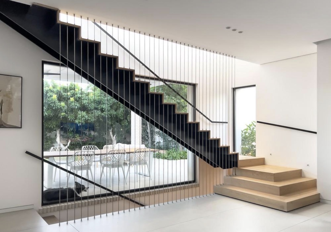 Floor-to-ceiling vertical cable balustrade around a modern stairwell